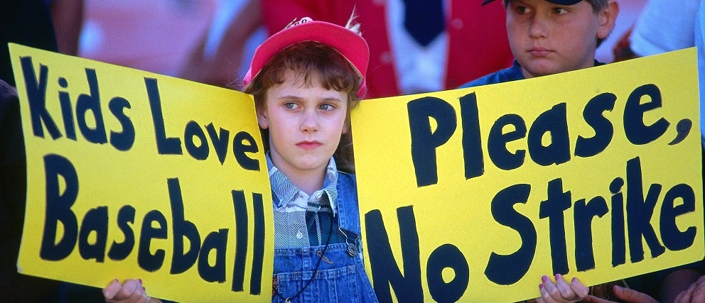  Baseball fan Erin States holds up signs that read "Kids love baseball" and "Please, no strike" before a game between the Seattle Mariners and Oakland Athletics at the Oakland Coliseum in Oakland, California on August 12, 1994. This was the last game played before the strike was called.